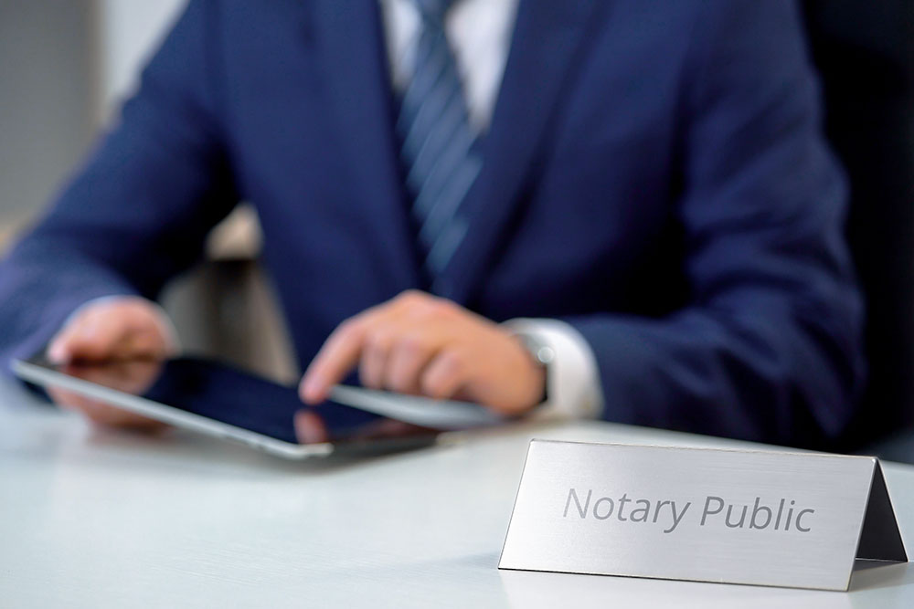 Young notary public working on tablet pc, preparing administrative documents