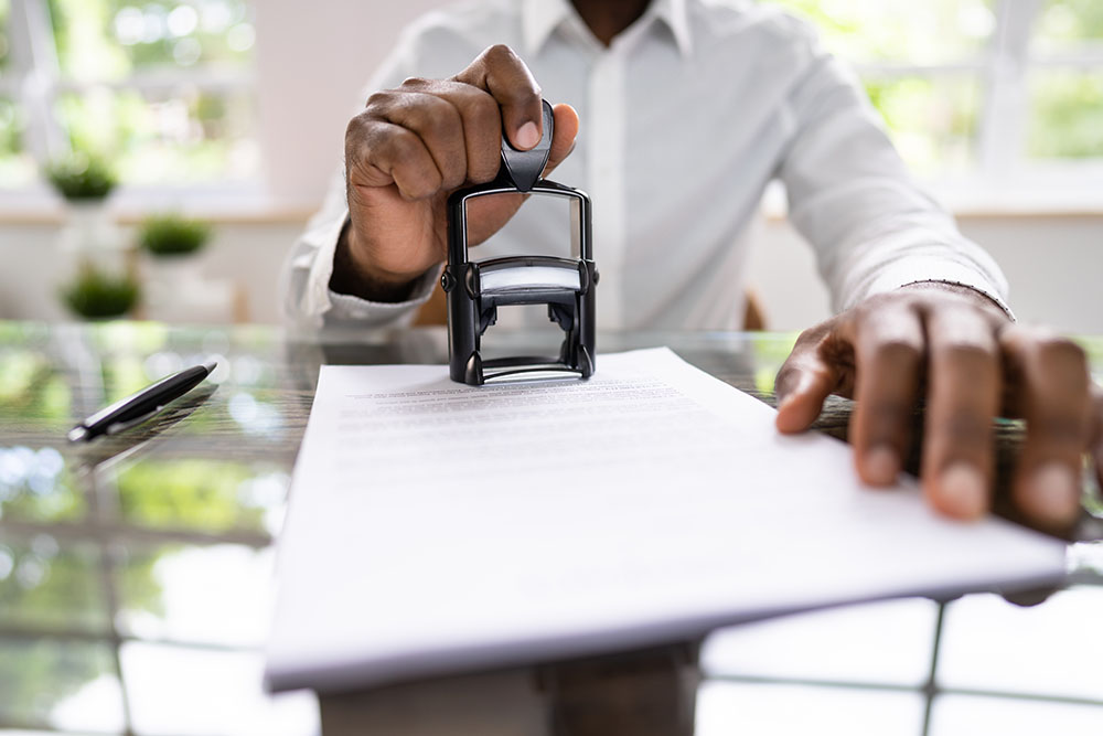 African American Black Man Using Notary Stamp On Official Paper