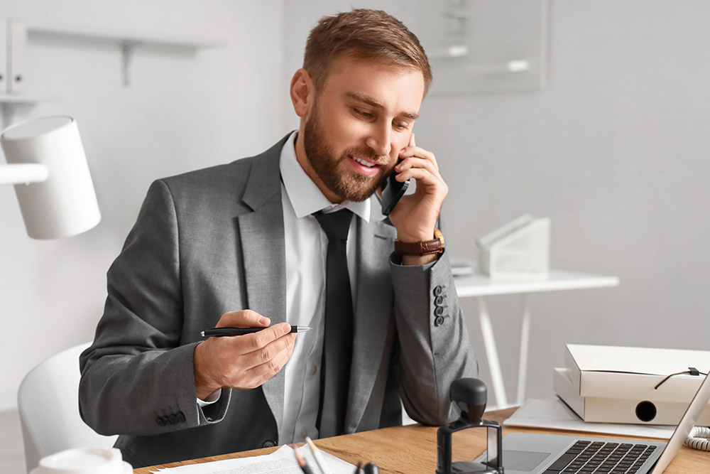 male notary public talking by phone in office