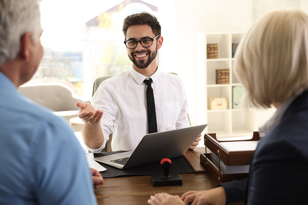 male notary working with mature couple in office