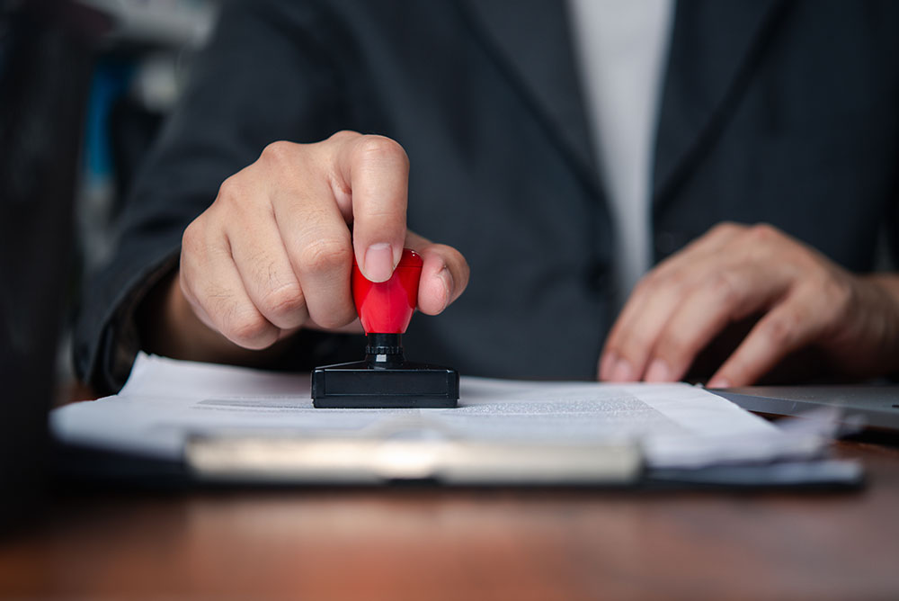 man stamping a notarized document