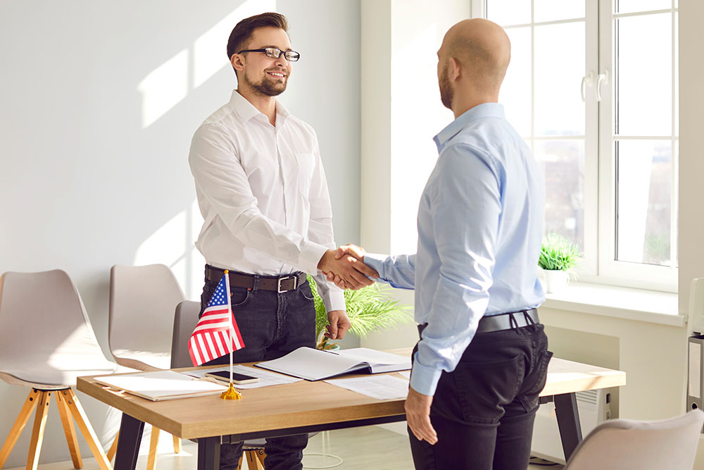 man shaking hands with an immigration client