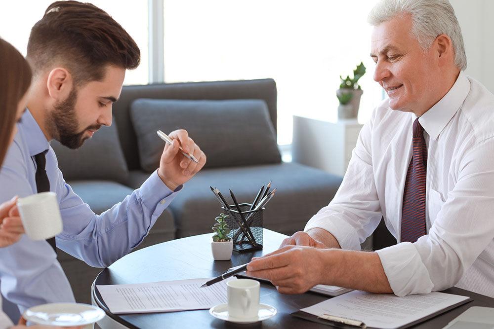 couple meeting with notary public in office