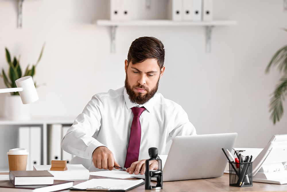 male notary public working in office