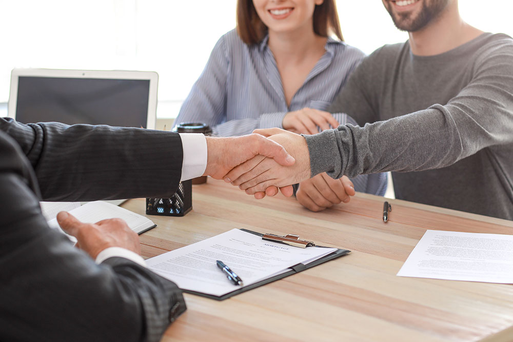 man shaking hands with notary public in office