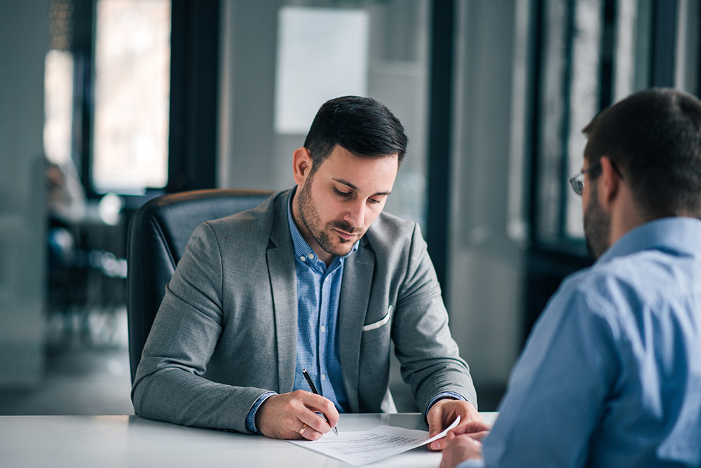 elegant man signing document, contract with manager.