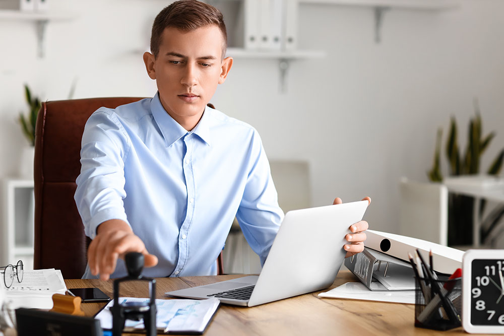young male notary public working in office