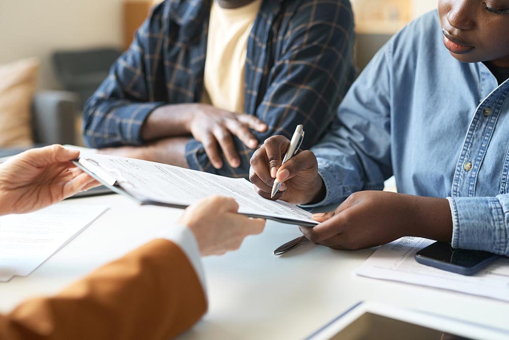 black couple signing will documents
