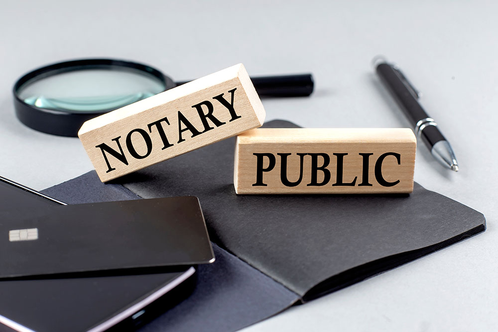 notary public text on wooden block on black notebook , business concept