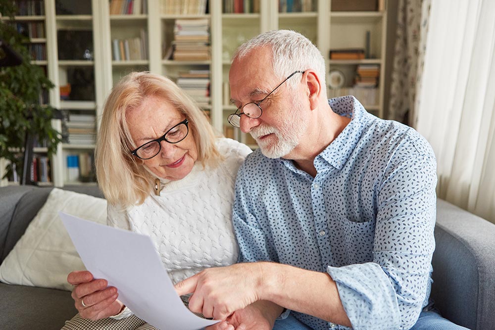 senior couple reading their will which is about to be notarized