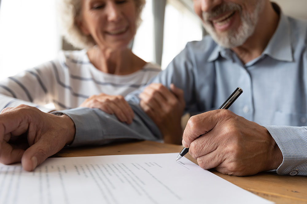 old couple make agreement sign insurance contract